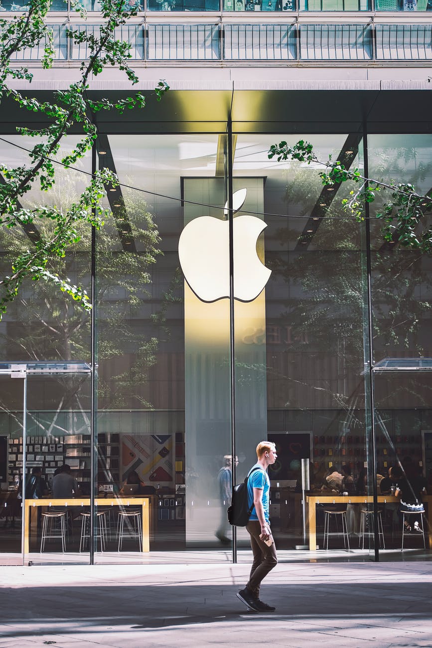 man passing an apple store