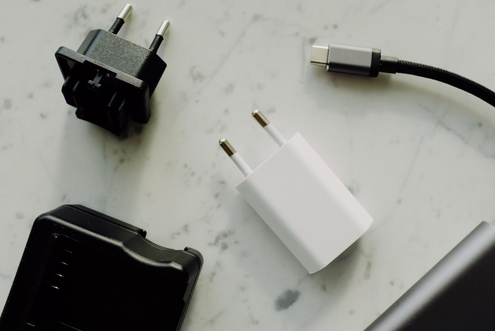 white and black adapter on white surface